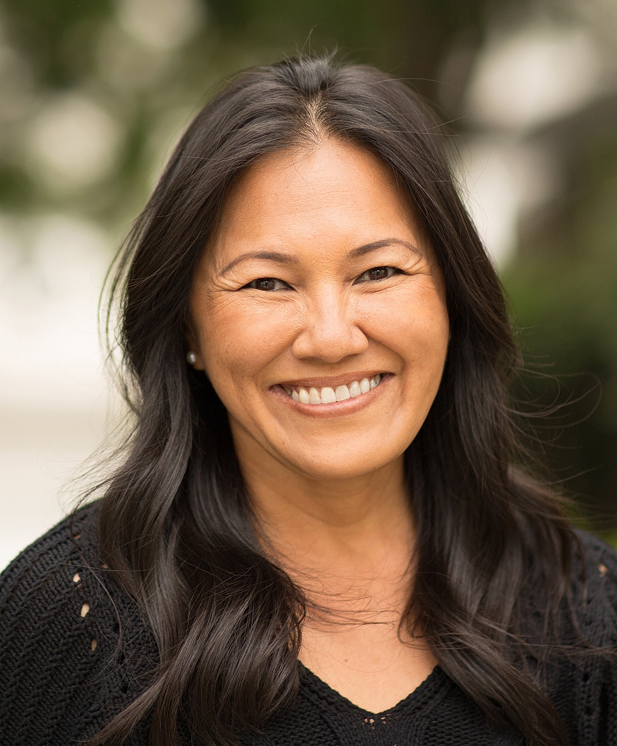 Happy woman smiling in outdoor setting.
