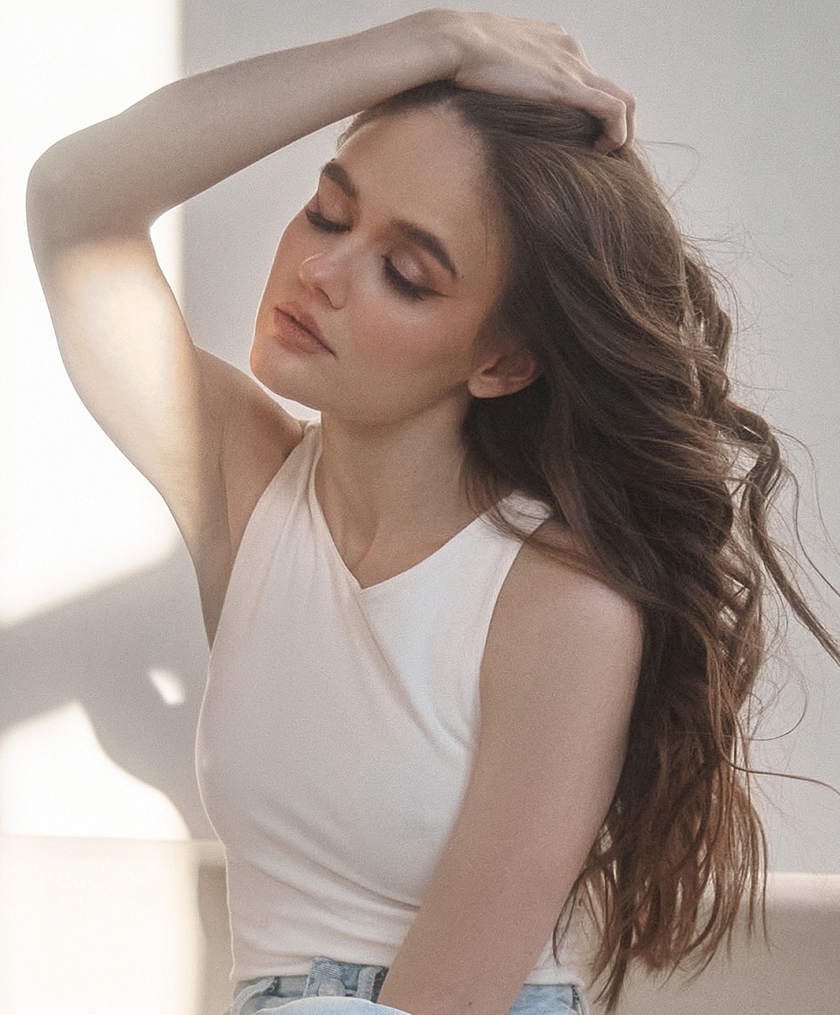 Woman posing with flowing hair and soft expression.