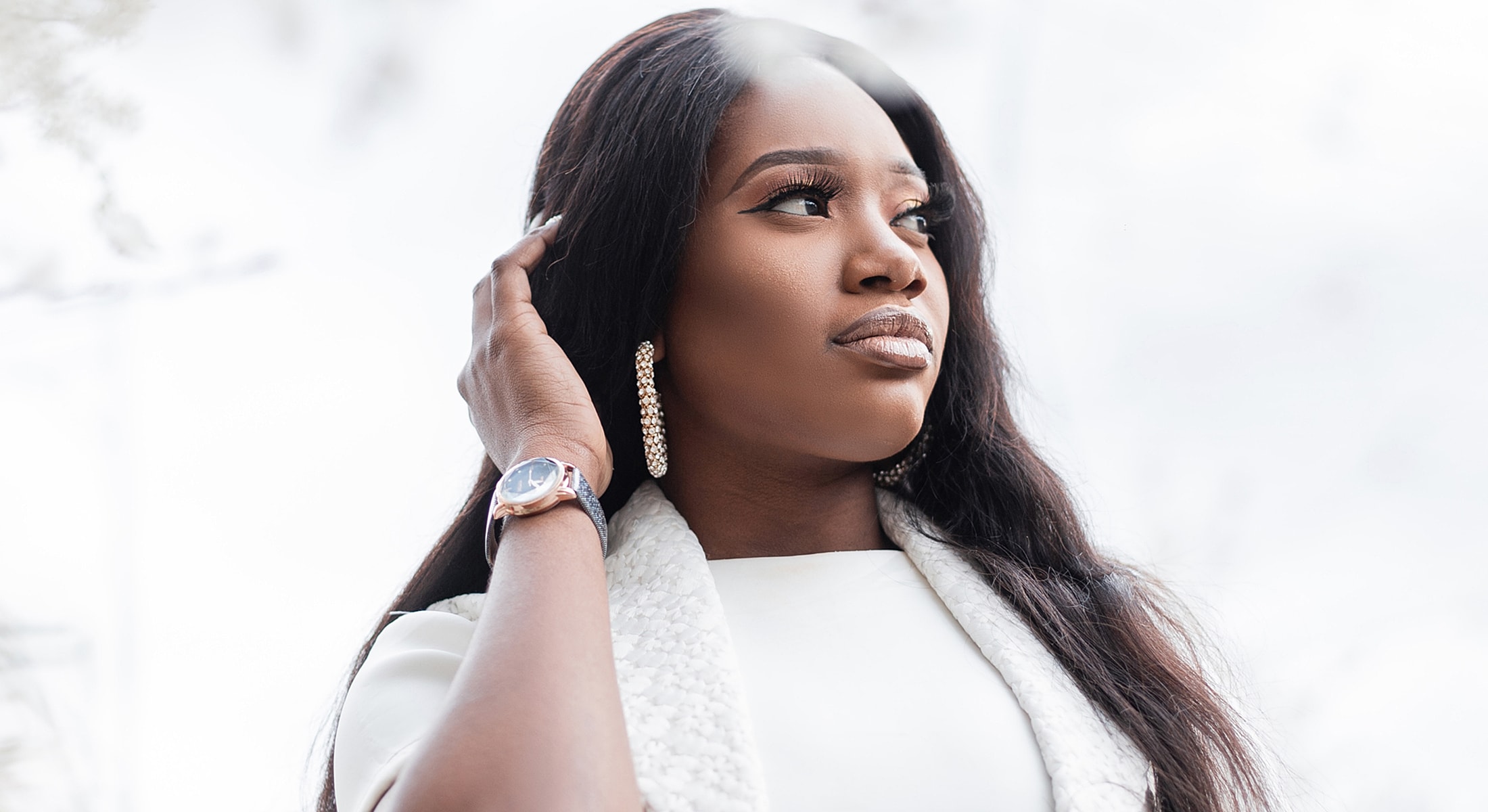 Woman with elegant hairstyle and stylish accessories.