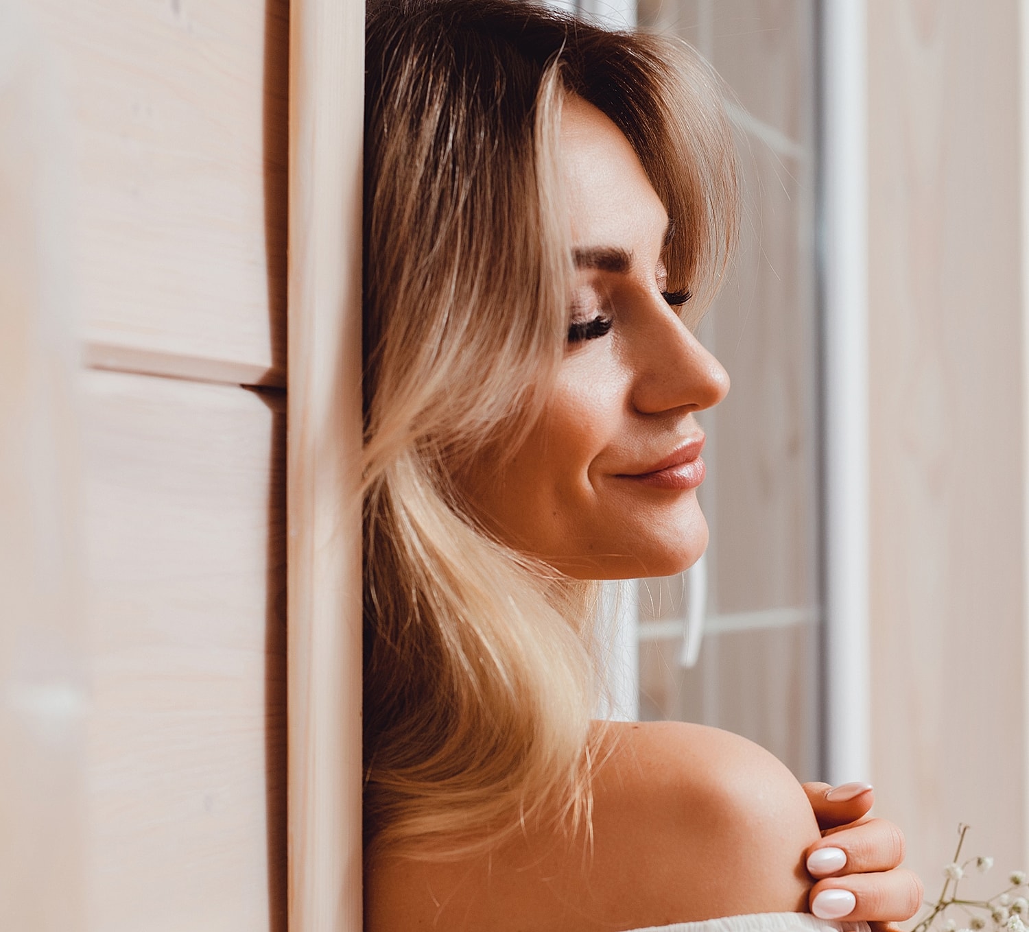 Woman with long hair wearing a white top.