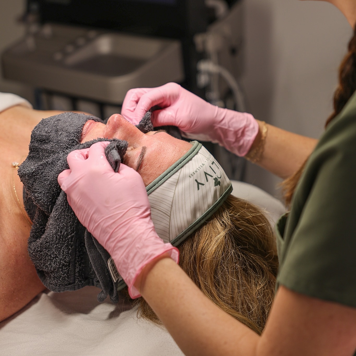 Woman receiving a facial treatment in spa.
